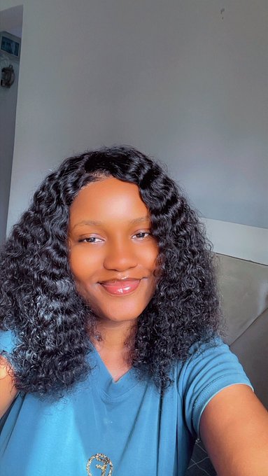 The image features a woman with curly hair wearing a blue shirt, smiling at the camera. The caption reads "Day 47 of smiling until @ritualnet Mainnet Stay cleansed Grituality to those that Grituality". This suggests that the woman is actively participating in a social media challenge or trend related to cleanliness and hygiene.
