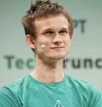 Vitalik Buterin, co-founder of Ethereum, speaks at a TechCrunch event wearing a headset microphone, as he shares his probabilistic predictions about SNARKs, FHE, and iO achieving single-digit overhead.