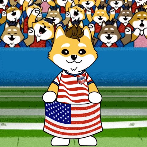 ursa shiba Inu dog, dressed as a soccer player, holds an American flag on a green field with a crowd of dogs and trees in the background.