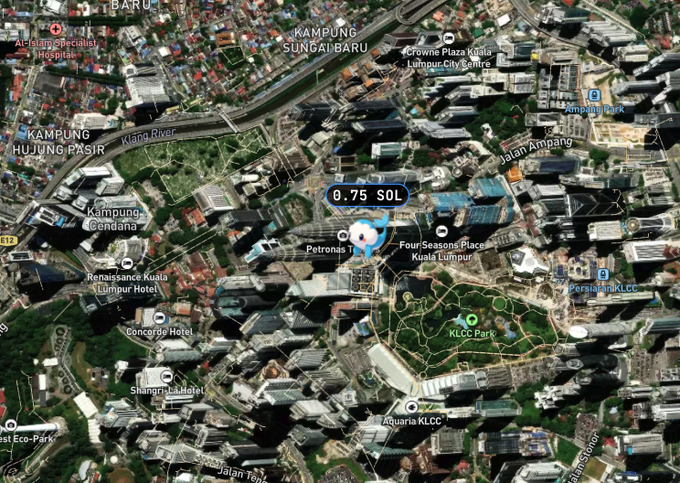 The image shows a map of Kuala Lumpur with various buildings and landmarks, including the Petronas Twin Towers. The map also includes information about a hotel located at 0.75 sol (0.76) and a park nearby. The text on the image suggests that there is an ongoing legal battle involving these buildings, possibly related to the Kuala Lumpur skyline.
