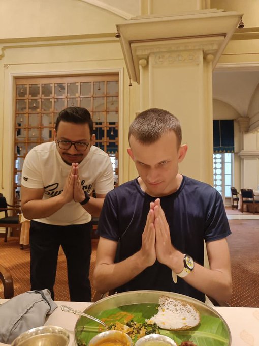 Two men pray with hands clasped over a large banana-leaf platter of South Indian food before sharing a meal. The accompanying post "Study Ethereum & Polygon" suggests this humble, grateful moment reflects a mindful break from intensive crypto study or team-building around blockchain research.