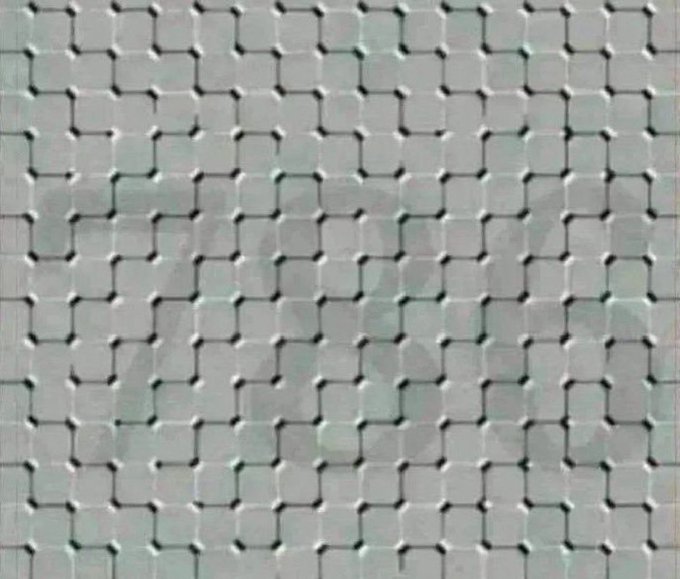 A close-up view of an expanded metal mesh with a diamond pattern of interlocking metal strands, featuring a faint watermark across the surface.