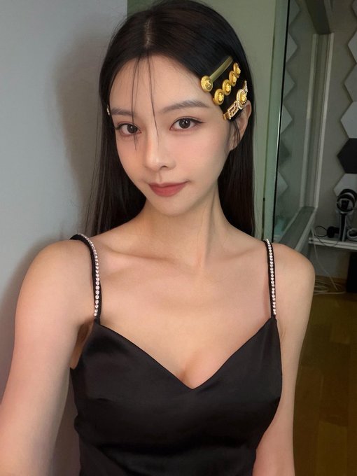A woman with long dark hair, gold hair accessories, and a black satin dress with rhinestone straps poses for a selfie, likely serving as a promotional teaser for the upcoming NFT holder meetup. The elegant, polished aesthetic aligns with the exclusive "preparing" announcement, suggesting a sense of sophistication and anticipation for the Sept 10/Sept 9 mint deadline.