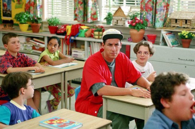 A visibly exhausted and overwhelmed adult man sits at a tiny elementary school desk surrounded by children, looking completely out of place and stressed. The image humorously captures the post's sentiment of feeling old and drained while navigating the chaotic, high-energy world of memecoin trading.