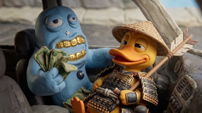 The image features a cartoon duck sitting inside of a car, with two toy figures - one dressed as a blue monster wearing gold armor and holding money, while the other figure is a person wearing a straw hat and holding an arrow. The background shows a car driving down a street, adding to the overall scene. The post includes information about upcoming NFT projects that are related to the characters in the image.