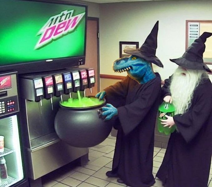 Two figures in witch costumes and pointed hats stand at a Mountain Dew soda fountain; one has a dinosaur mask and holds a cauldron filled with glowing green soda, while the other holds a bottle of the drink.
