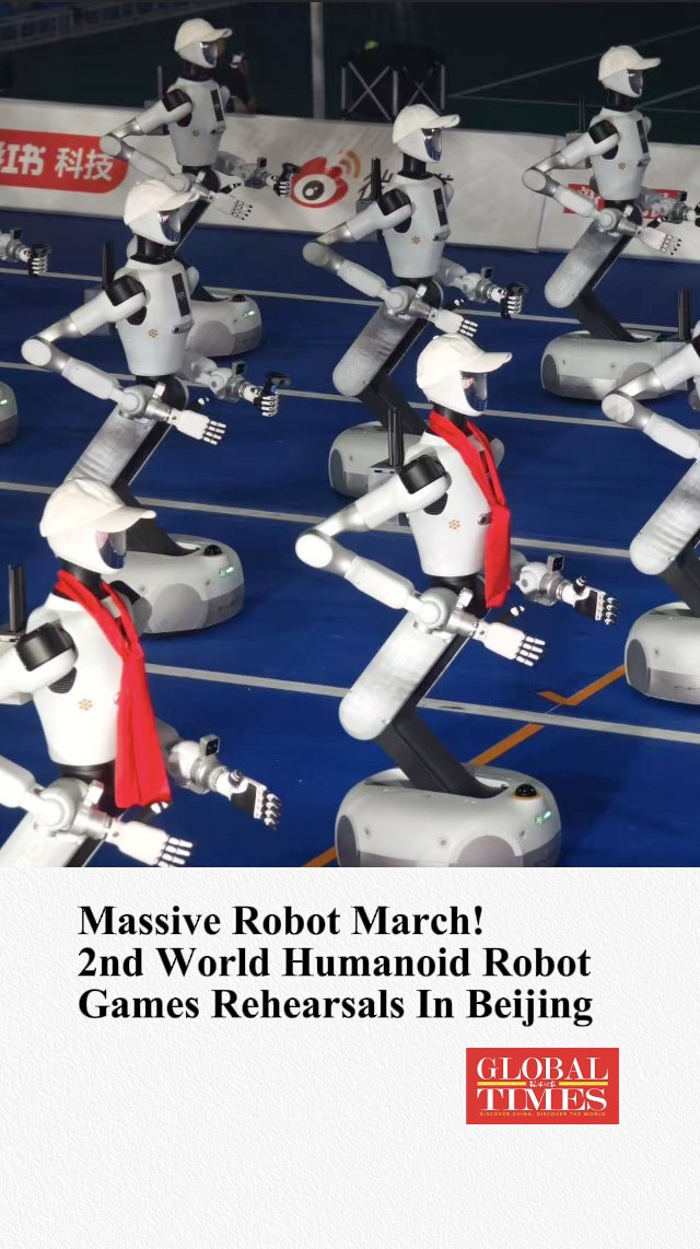 A group of humanoid robots wearing white caps and red scarves perform a synchronized march during rehearsals for the 2nd World Humanoid Robot Games in Beijing. The image highlights the rapid advancement of robotics technology, which the post connects to undervalued crypto robotics projects like $SR, $CASPIUS, $PEAK, and $VADER, suggesting the sector is still in early growth stages.