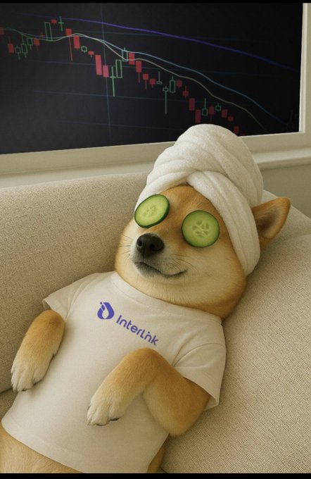 A Shiba Inu dog relaxes on a couch wearing a white "InterLink" t-shirt and a towel on its head, with cucumber slices over its eyes, appearing to be undergoing a spa-like "maintenance" session while a bearish stock chart is visible in the background—symbolically tying the project's $ITLG token maintenance period to a recovering, refreshed launch of v6.0.2.