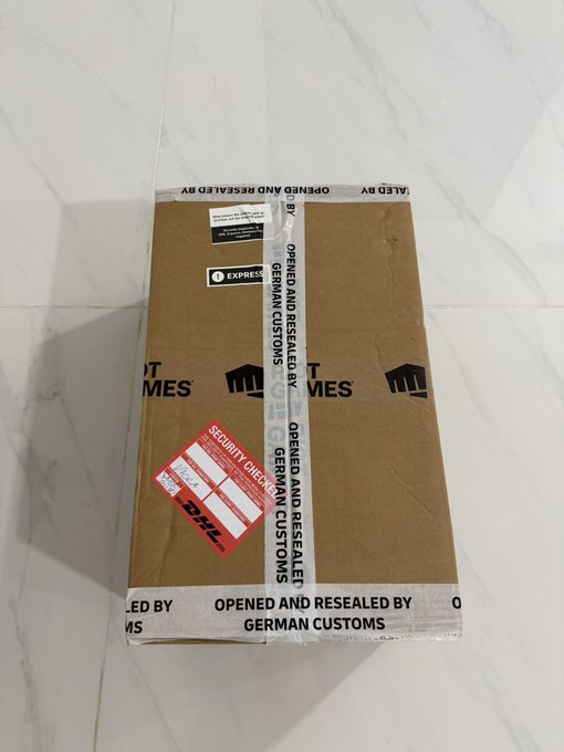 A DHL shipping box sealed with "OPENED AND RESEALED BY GERMAN CUSTOMS" tape, bearing a red DHL security check sticker, indicating the T1 x Riftbound signature set was successfully delivered to its buyer after passing through international customs.