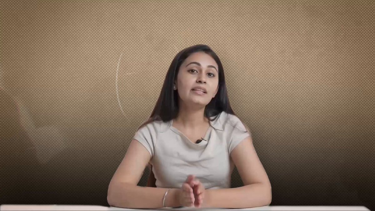 The image shows a woman sitting at a desk with her hands clasped together while looking directly at the camera. The background features a brown wall with white polka dots, creating an interesting visual effect. The caption of the image reads "Every EOA on Ethereum (MetaMask, hardware wallets, etc.) relies on elliptic curve signatures. Quantum computers are coming for those keys. EIP-8141 brings native account abstraction, letting accounts move beyond fixed signatures to quantum-safe authentication". This text is related to the woman's position in front of a computer screen and her interaction with the digital world.