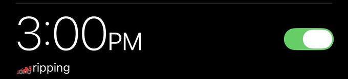 A dark-themed lock screen or widget displaying "3:00PM" with the word "ripping" and a small red icon next to it, alongside a green toggle switch.