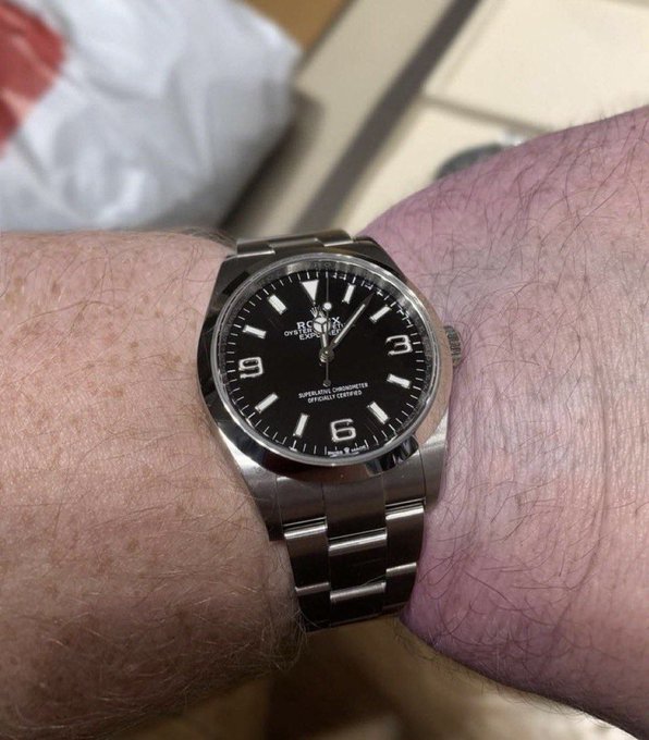 A wrist wears a black-dial stainless-steel Rolex Oyster Perpetual, showing large numerals “3,” “6,” and “9” and text including “ROLEX,” “OYSTER PERPETUAL,” and “SUPERLATIVE CHRONOMETER OFFICIALLY CERTIFIED.” The close-up, shaky-feeling photo matches the post’s excitement: “I’m literally shaking rn Thank you @Pumpfun.”