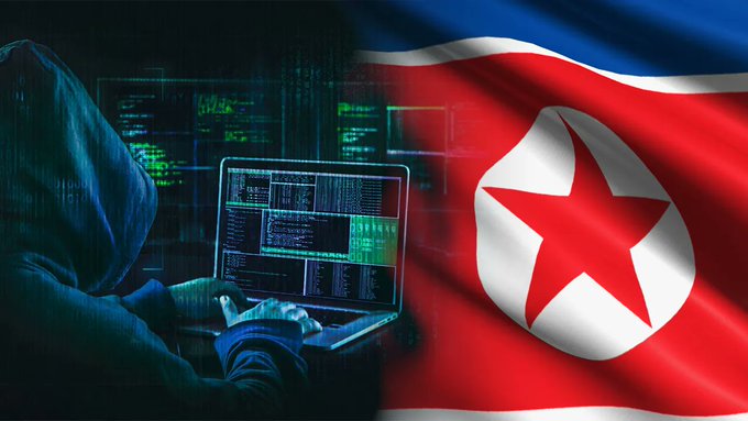 A hooded figure types on a laptop with green code displayed on the screen, juxtaposed against the North Korean flag with its distinctive red star.