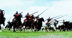 The image shows a group of people riding horses, with some of them holding long sticks or swords as they run across a field. The scene appears to be from an old-time battle or reenactment, possibly set in medieval times. There are at least ten people visible in the image, each riding their horse and engaged in the activity. 

The post is about buying signals for the stock market, but it seems unrelated to the main event captured in the image. The focus of the post should be on the historical context or significance of the scene depicted in the photo.