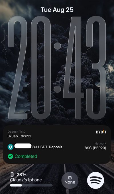 An iPhone lock screen from Tue Aug 25 displays the time 20:43 over a stormy sky wallpaper, showing a completed Bybit USDT deposit of an obscured amount on the BSC (BEP20) network.