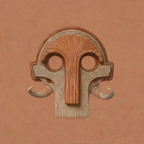 A stylized stone mask or face carving with large circular eyes, a long ridged nose, and curled tusks or horns, set against a warm terracotta background.