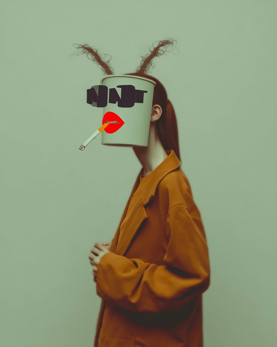 An artistic portrait shows a woman in an orange jacket with a white paint bucket labeled 'NINI' covering her face, featuring painted red lips, a cigarette, and pipe-cleaner antennae on her head.