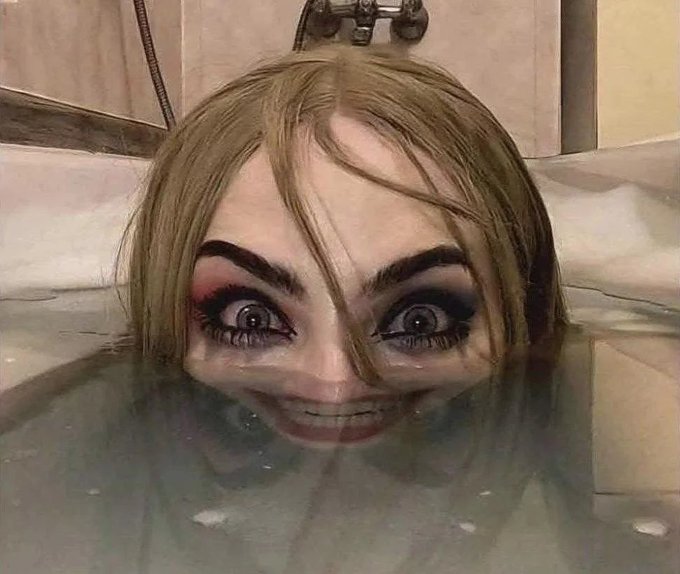 A disturbing image of a person submerged in a bathtub filled with murky water, with heavy, smudged black and red makeup around their eyes and a wide, unsettling smile.