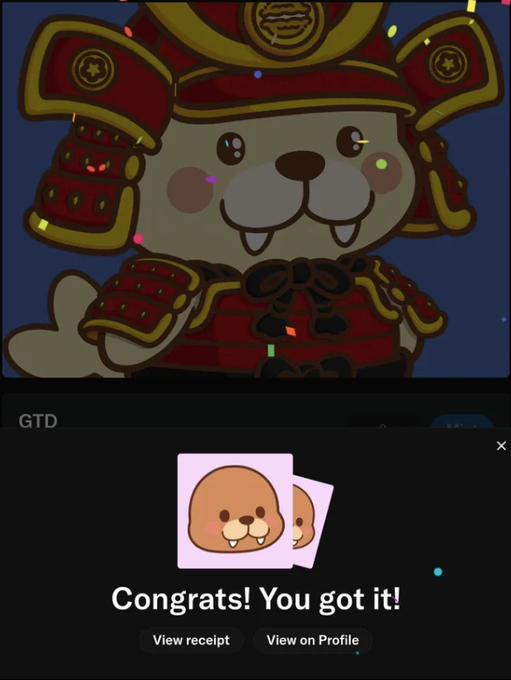 A screenshot showing a cartoon bear character in red samurai armor with a 'GTD' watermark, alongside a pop-up notification that reads 'Congrats! You got it!' featuring a small brown beaver sticker.