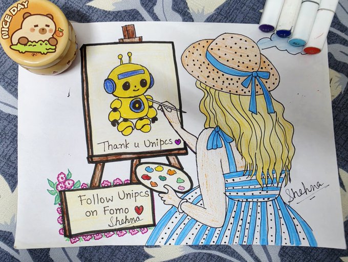 A hand-drawn illustration shows a girl with long blonde hair, a polka-dot sun hat with a blue ribbon, and a blue striped dress painting a yellow robot on an easel. The artwork includes text reading 'Thank u Unipcs' on the canvas, 'Follow Unipcs on Fomo ♥ Shehna' on a sign below, and the artist's signature 'Shehna' on the right.