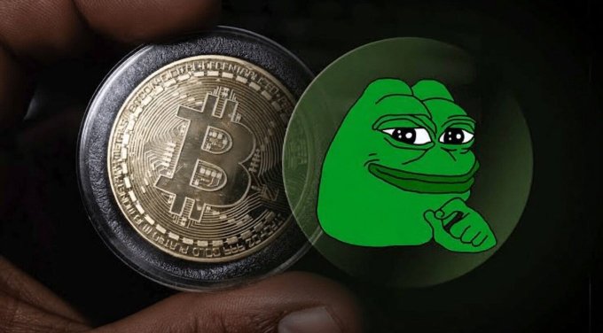 A hand holds a physical Bitcoin token beside a Pepe the Frog emoji, symbolizing the continuing dominance of Bitcoin and the persistent popularity of meme coins in the crypto space.