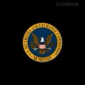 A small, low-resolution image displays a circular seal or logo with a blue and gold color scheme on a black background.