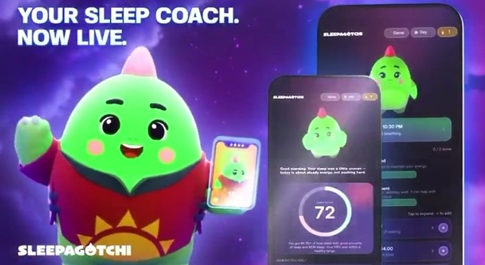 The image features a cartoon character, likely a green frog, holding a cell phone with an app displayed on its screen. The text "Your sleep coach now live" is written above the frog's head, indicating that the app is available for use. The background of the image is dark purple and has stars scattered throughout it.