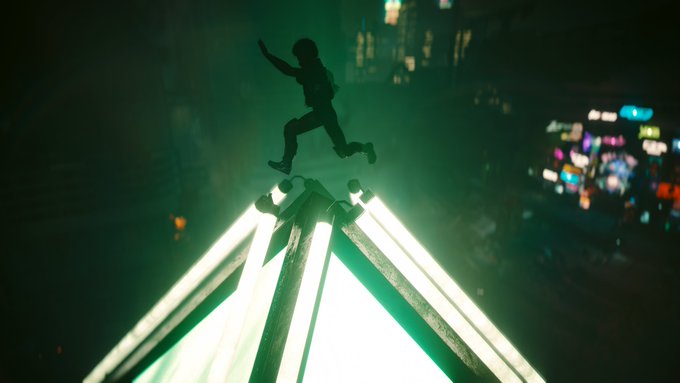 A silhouette of a person leaping in mid-air above a glowing, pyramid-shaped neon light structure at night, with city lights blurred in the background.