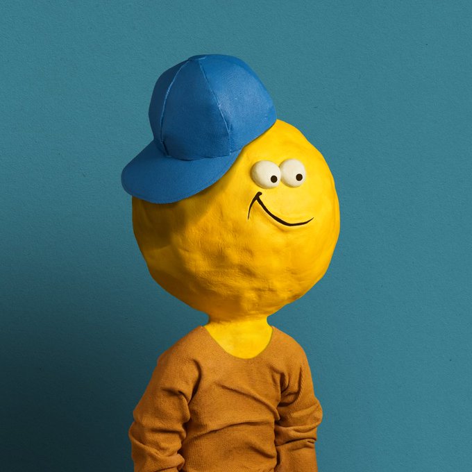 A figure with a round yellow smiley-face head wearing a blue baseball cap and a mustard-colored long-sleeve shirt stands against a teal background.
