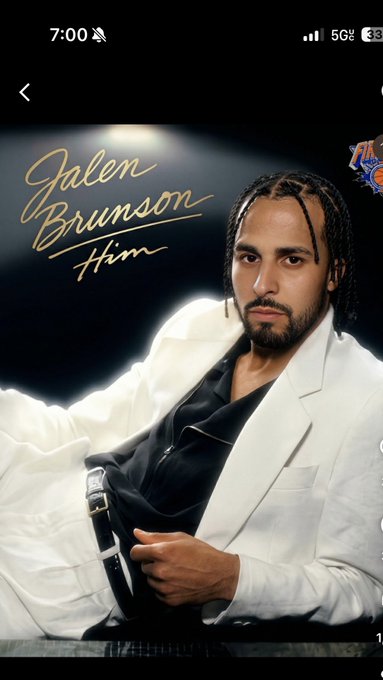 A mobile phone screenshot showing a photo of basketball player Jalen Brunson in a white suit jacket and black shirt, with the cursive gold text 'Jalen Brunson Him' overlaid on a dark background.