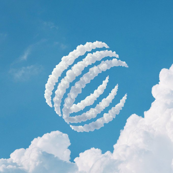 An illustration of a stylized spiral or globe logo formed by white clouds against a bright blue sky with scattered clouds.