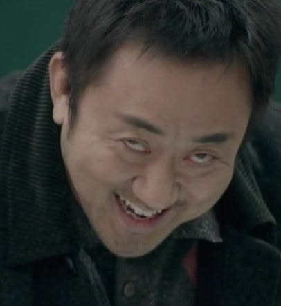 A close-up shows an Asian man in a dark jacket smiling with a slightly eerie or mischievous expression, looking off to the side.