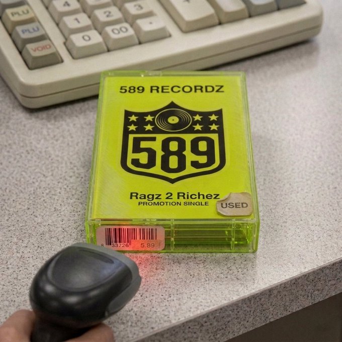 A neon-green cassette labeled “589 RECORDZ,” “Ragz 2 Richez,” and “PROMOTION SINGLE” sits by a calculator and barcode scanner, with a “USED” sticker and item 589 visible. It previews forthcoming music artwork being prepared for OpenSea and Robinhood Chain.