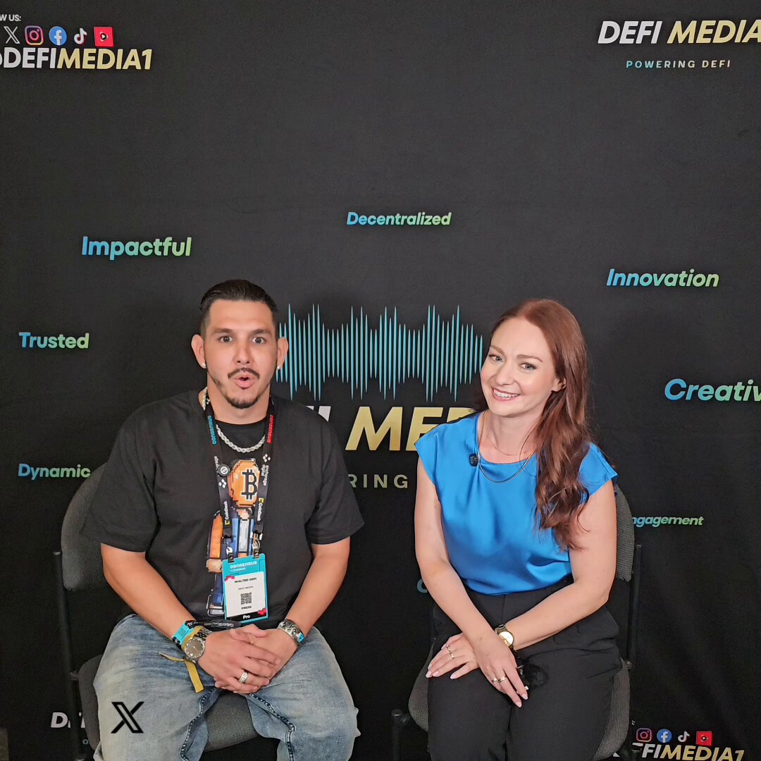 The image shows a man and woman sitting next to each other against a black background with white text. The woman is wearing a blue shirt, while the man has a beard. They appear to be posing for a photo or participating in an interview. The backdrop features words such as "DEDMINE Media", "FOUNDATION", " Crypto Adoption", and "THE FUTURE OF DIGITAL FINANCE". It seems that they are discussing the future of digital finance, with a focus on the continued evolution of crypto technology and its impact on the financial landscape.