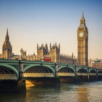 The image shows the iconic Big Ben clock tower and the Houses of Parliament alongside Westminster Bridge in London, UK. This scene visually represents the UK as the location where the Treasury's new crypto regulation amendments were proposed, with the partial text "Katie" visible referencing Coinbase's head of European policy mentioned in the accompanying message.