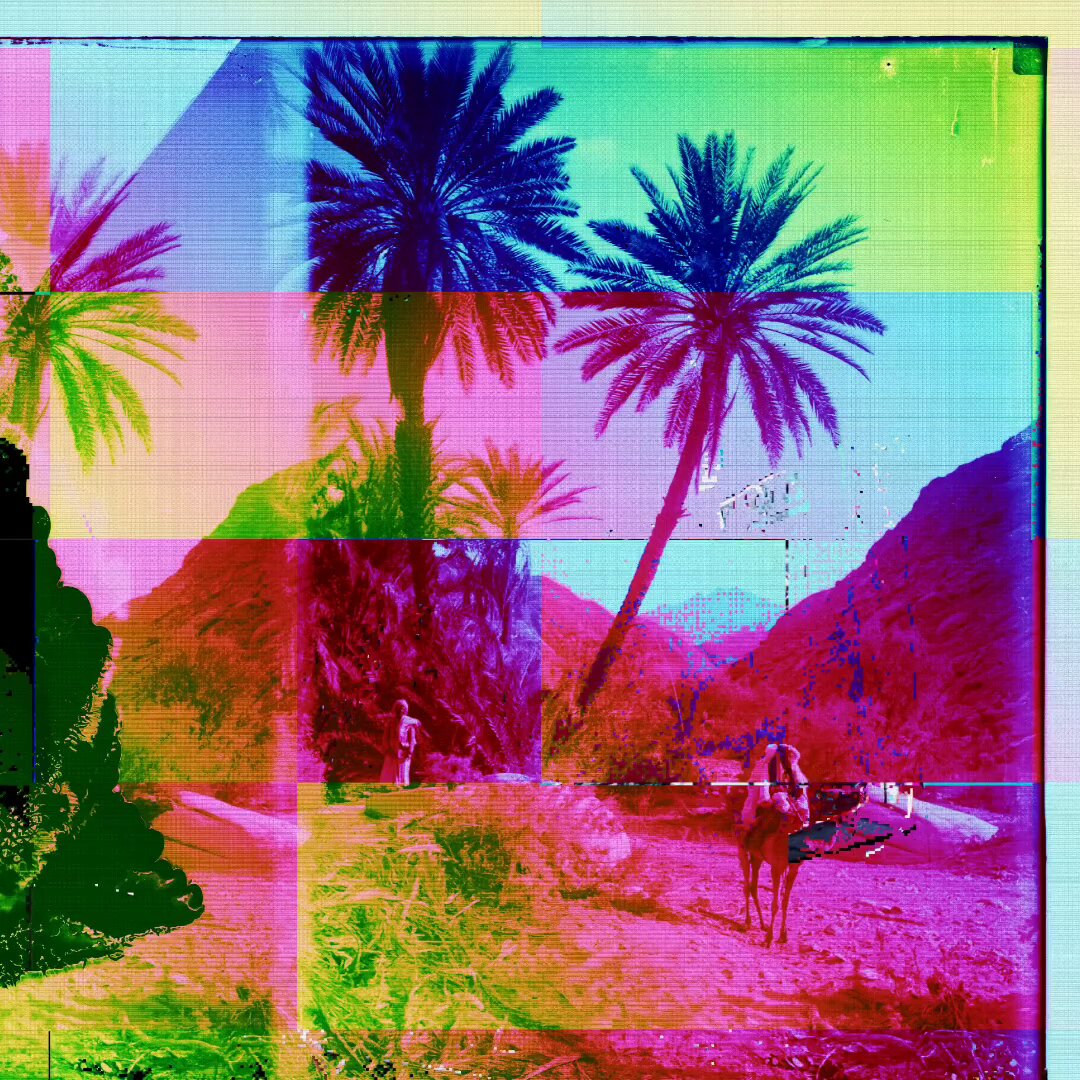 The image features a collage of palm trees and mountains, creating an artistic and colorful scene. The photo has been edited with a filter that gives it a rainbow appearance, adding a vibrant touch to the landscape. In the foreground, there are two people walking on a dirt road surrounded by palm trees. One person is closer to the left side of the image while the other is more towards the center. The background includes mountains and a desert-like setting, providing a sense of depth and scale to the scene.