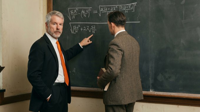 A distinguished older man with gray hair and an orange tie points to mathematical equations on a chalkboard while a younger man in a tweed jacket holds a book and observes, embodying the image of a professor teaching a student.

The scene visually reinforces the caption's portrayal of Saylor as an educator, depicting the classic mentor-student dynamic through the act of teaching complex formulas on a chalkboard—mirroring how Saylor shares knowledge in podcasts, interviews, and keynotes.