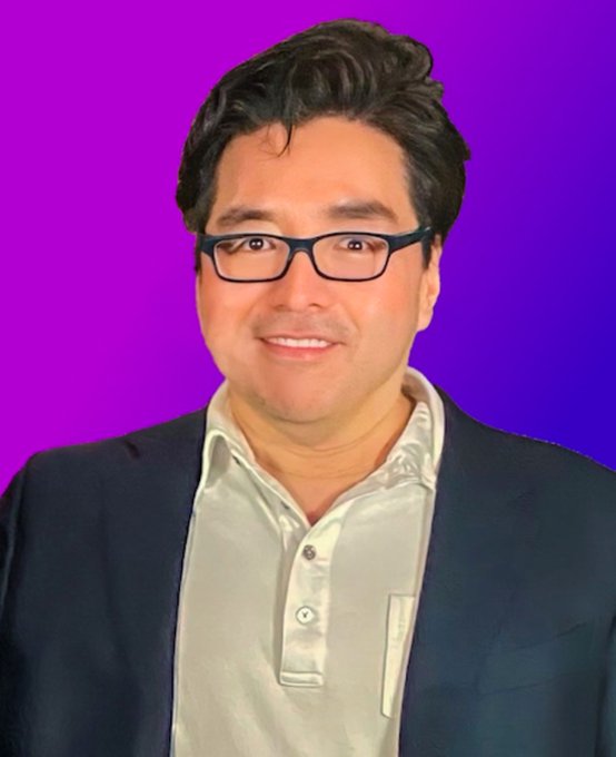 Tom Lee, the well-known market strategist, poses for a portrait with a purple background. The image accompanies news about his bullish prediction that Ethereum has outperformed the S&P 500 by 5,866 basis points in Q3.
