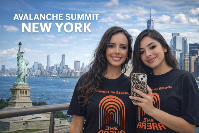 Two women pose for a selfie in front of the New York City skyline and Statue of Liberty, with text reading 'AVALANCHE SUMMIT NEW YORK' and t-shirts displaying 'There Is No Escape' and 'THE ARENA'.