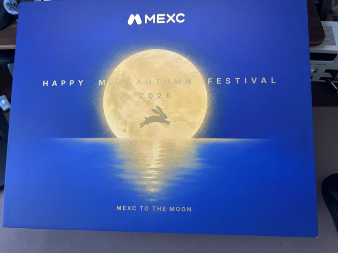 A blue promotional box for MEXC celebrating the 'Happy Mid-Autumn Festival 2026' with 'MEXC TO THE MOON' and an image of a moon reflecting on water with a rabbit silhouette.