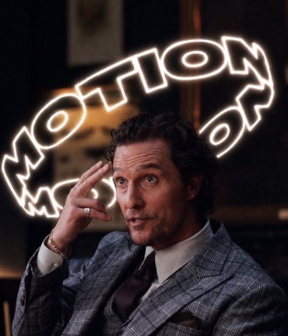 The image shows a man in a gray plaid suit gesturing with his hand near his head, with a glowing neon "MOTION" sign illuminated in the background. The caption references the ticker $MOTION and quotes the man, suggesting a confident "billions" prediction, fitting with the post's commentary on the stock.