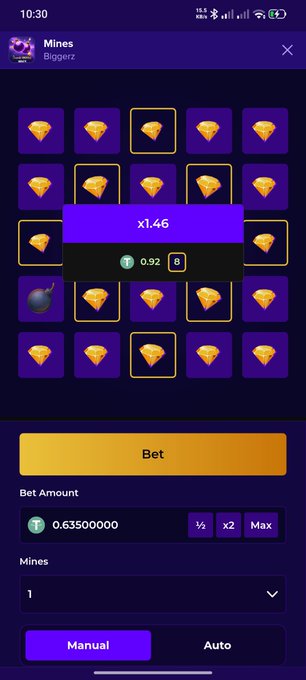 A mobile game screenshot showing a 'Mines' gambling game interface with a 5x5 grid of croissants, a 1.46x multiplier popup, a bet amount of 0.635, and options for Manual or Auto play.