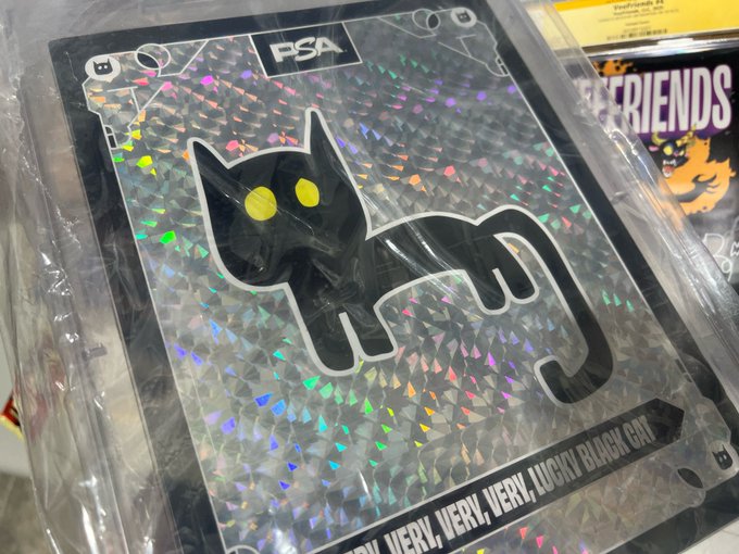 A PSA-graded holographic Pokémon card featuring a black cat illustration with the caption "VERY, VERY, VERY LUCKY BLACK CAT" visible at the bottom.