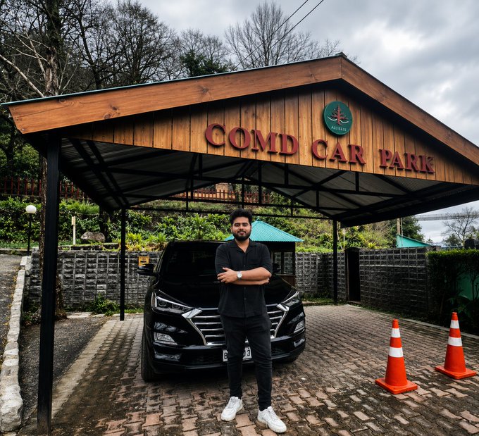 A young man poses confidently in front of a black luxury SUV at "COMD CAR PARK," visually complementing his post about his impressive Web3 achievements by age 24, including building growth strategies for 50+ NFT launches and helping brands raise $10M.