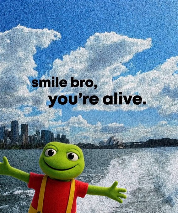 A motivational poster featuring a smiling frog character in red shirt and yellow overalls with the text "smile bro, you're alive." against a backdrop of clouds and a city skyline over water.
