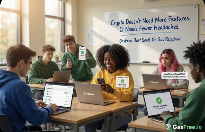 The image shows a group of people sitting at desks with laptops open in front of them. They are all smiling and appear to be enjoying themselves, possibly working together or participating in an educational activity. The background includes a whiteboard that has text on it, which reads "Crypto Doesn't Need More Features. It Needs Fewer Headaches." This message seems to be related to the image's theme of people using laptops for various tasks and the importance of simplicity and efficiency when it comes to cryptocurrency usage.