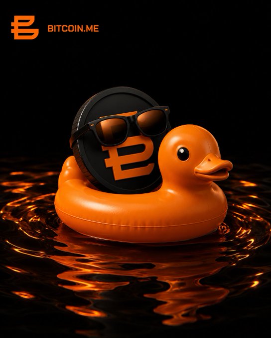 A 3D illustration shows an orange rubber duck wearing black sunglasses floating in dark liquid, holding a black Bitcoin coin with an orange logo; text reads 'BITCOIN.ME' in the upper left corner.