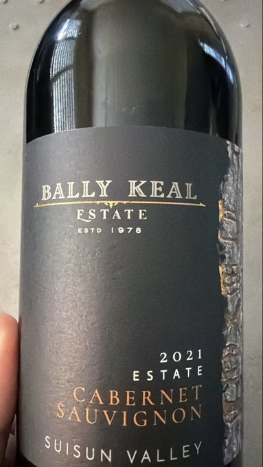 A close-up of a dark wine bottle labeled 'BALLY KEAL ESTATE, ESTD 1978, 2021 ESTATE, CABERNET SAUVIGNON, SUISUN VALLEY'.