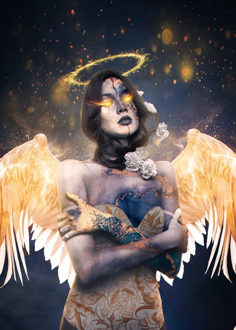 A fantasy-style portrait of a woman with glowing orange eyes, angel wings, and a golden halo, with cracked dark makeup on her face and floating particles in the background.