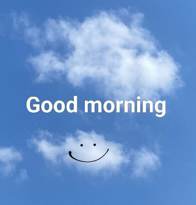 A cheerful 'Good morning' greeting featuring a smiling face formed by a small cloud against a bright blue sky with scattered white clouds.